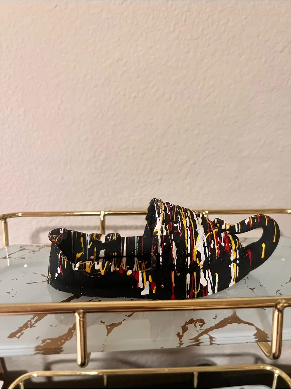 Hand-Painted Black Decorative Shoe Accent with Red, Yellow & White Drip Design